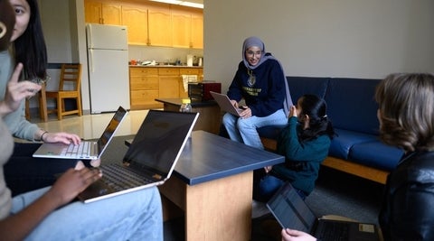 students sitting in a suite style living room