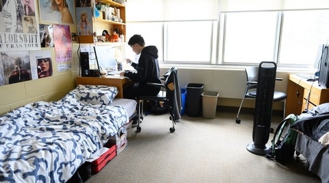 student sitting in a double room