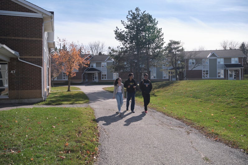 Columbia Lake Village South exterior with three students walking.