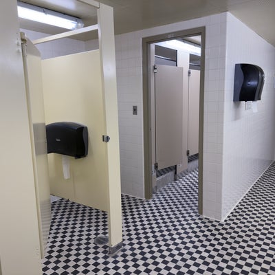 Village 1 washroom showing the toilet and shower stalls (with doors).