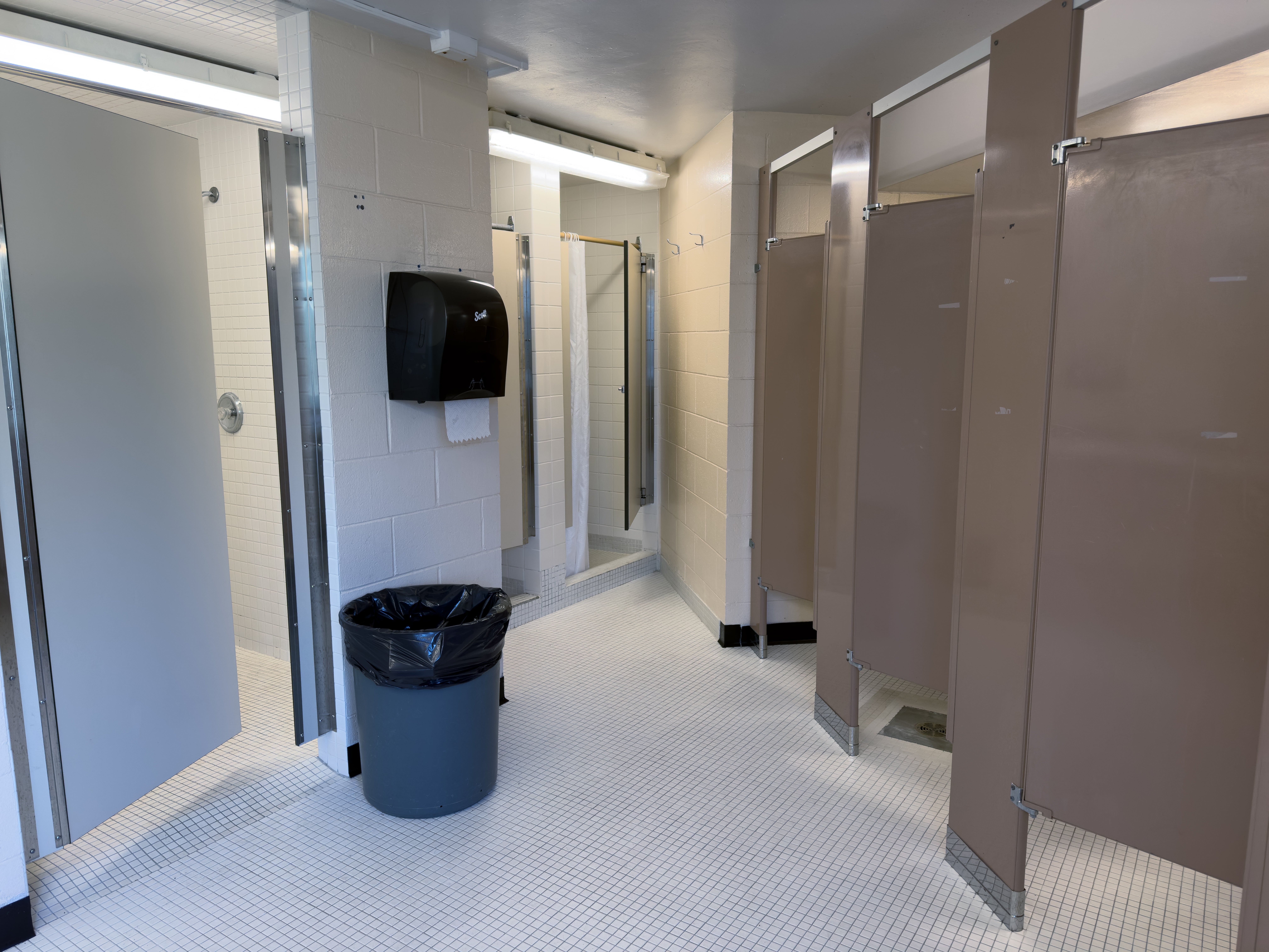 Ron Eydt Village washroom showing toilet stalls and shower stalls with doors