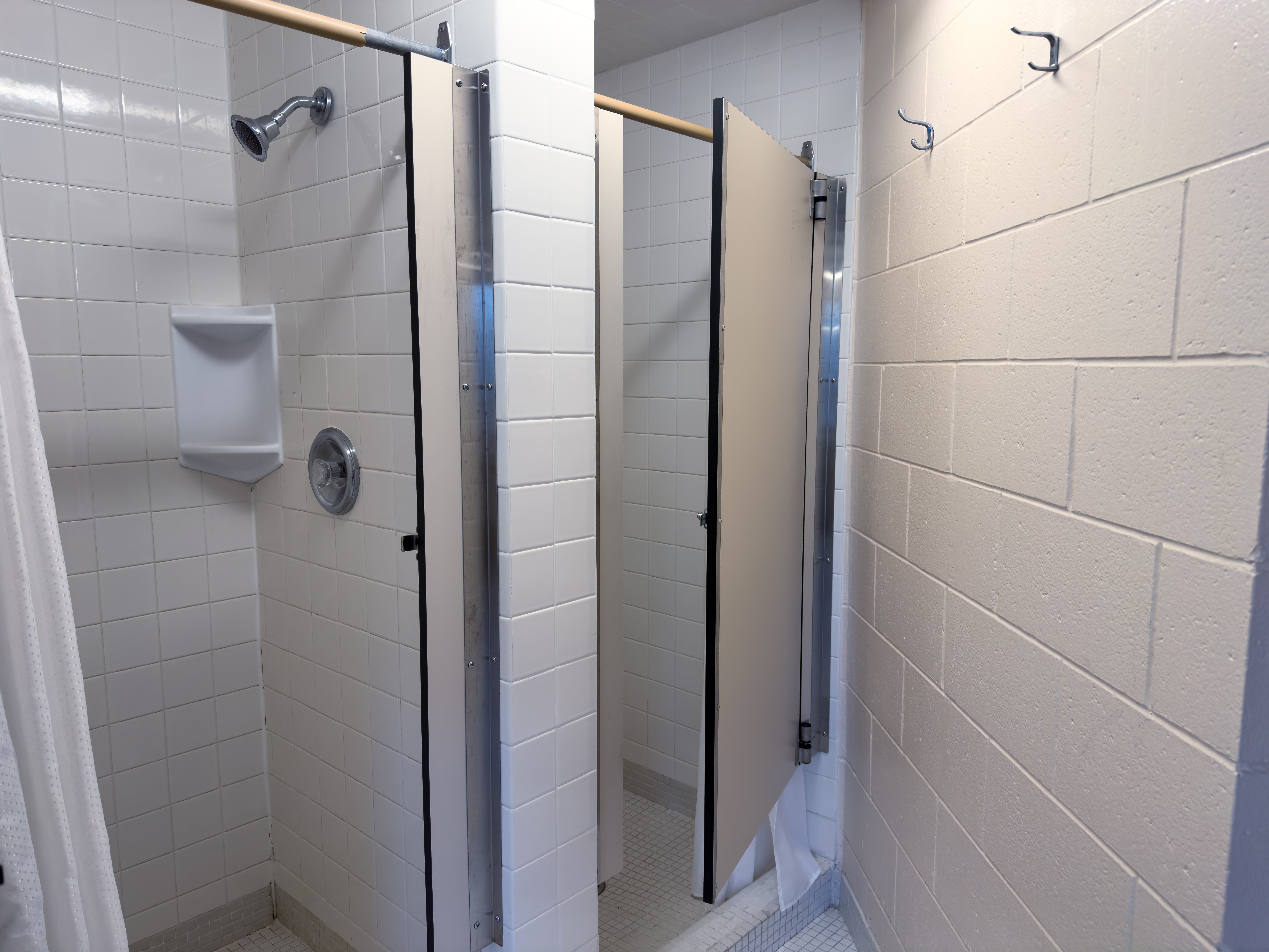 Ron Eydt Village washroom shower stalls with doors.