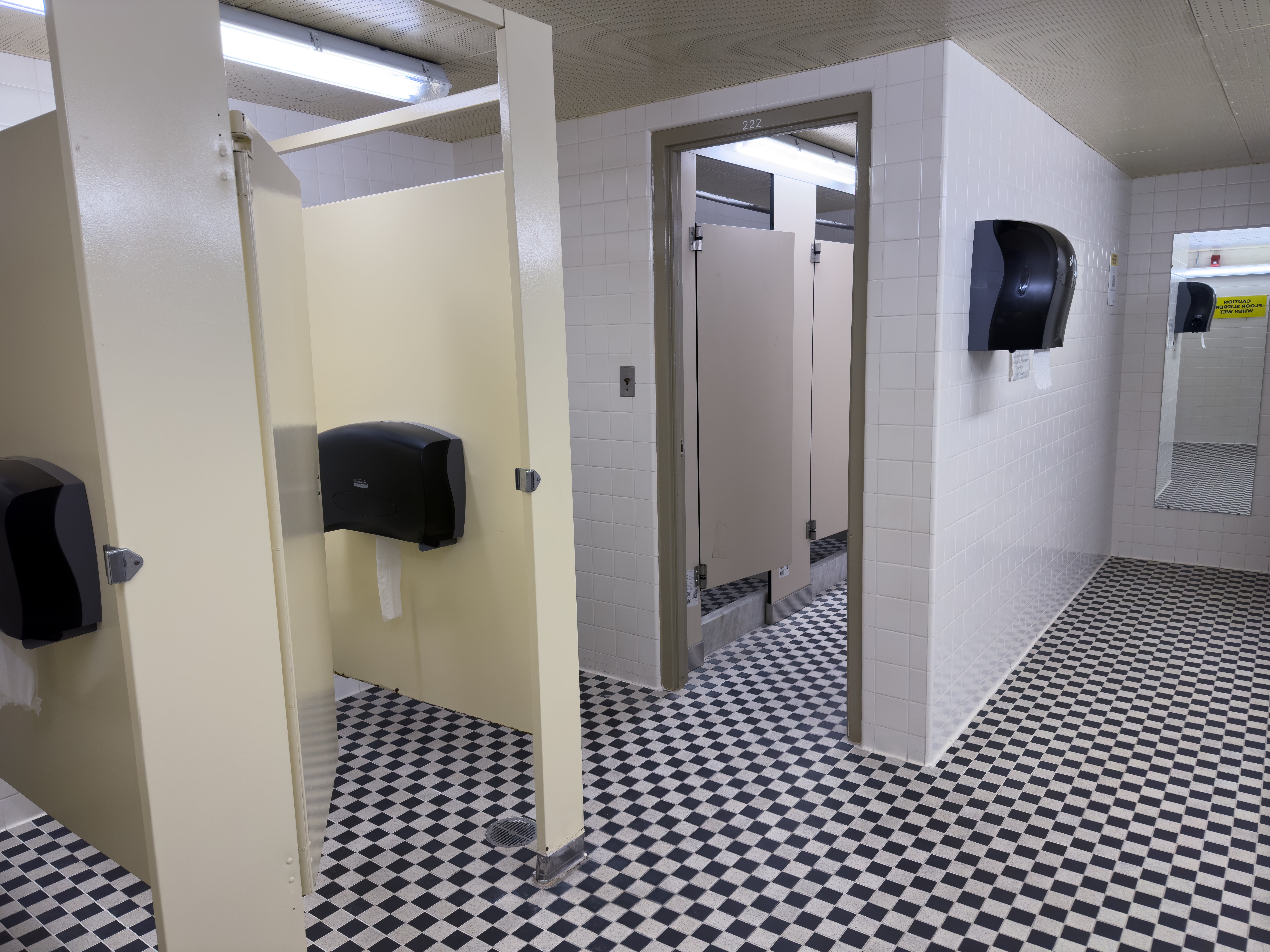 Village 1 washroom showing the toilet and shower stalls (with doors).