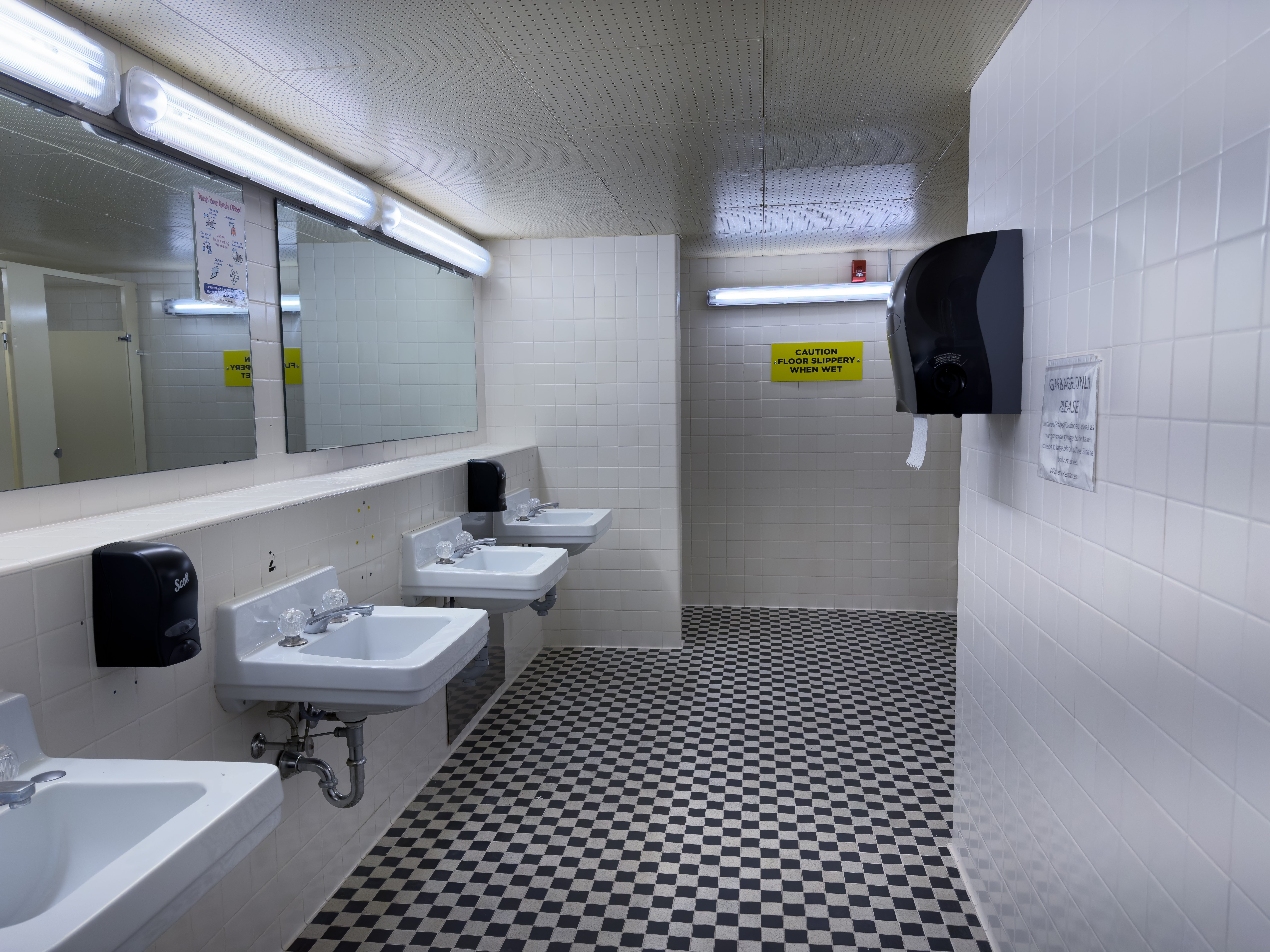 Village 1 washroom showing sinks and mirrors. 