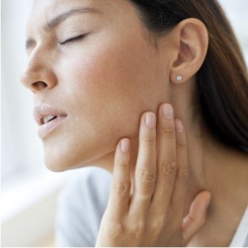 Female patient taking her own pulse at neck.