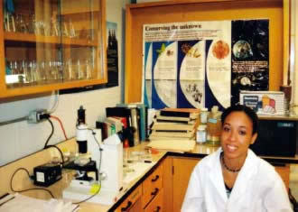 Angie Gonzales sitting in a lab