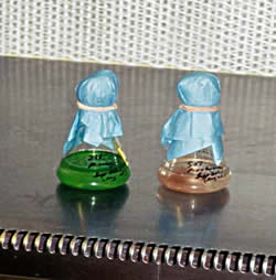 two flasks with coloured substances inside