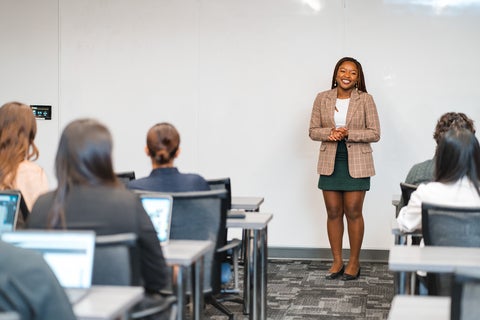 woman standing in front of class