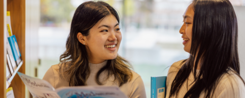 Two students looking at further education booklets in the Tatham Centre