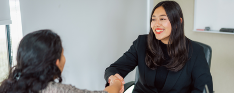 Grad student shaking hands with career advisor during appointment