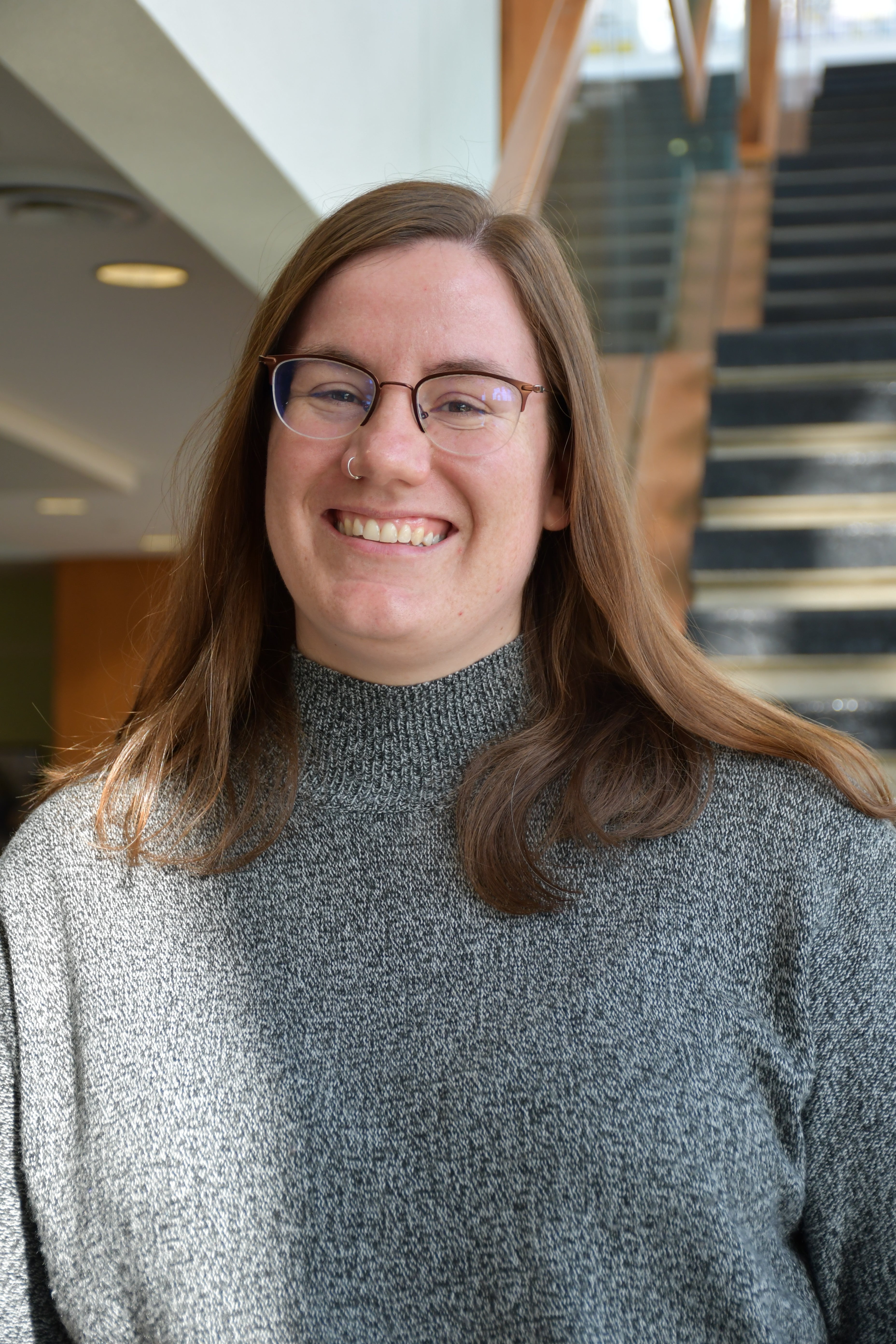 Woman standing on stairs smiling