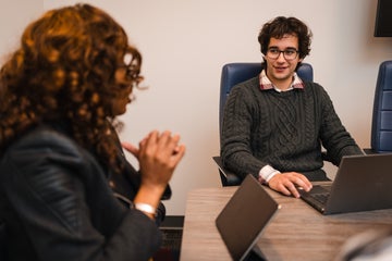 man and woman talking at table