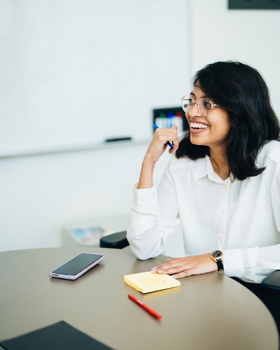 woman sitting at desk smiling