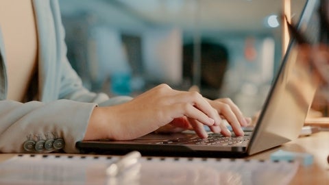 person typing on laptop