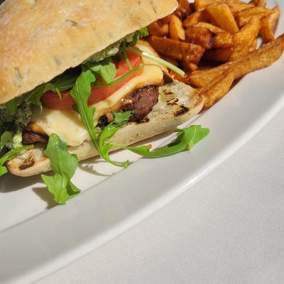 Grilled lamb burger with mint chutney, smoked gouda cheese, lettuce, tomato and a side of fries 