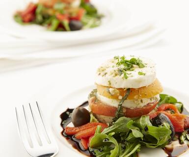 Caprese salad served on a white plate