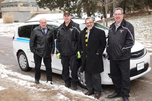 Vice-President, Administration and Finance Dennis Huber, Rob McMurren of Central Stores, President Feridun Hamdullahpur, and Joel Norris, manager of Central Stores with the new van.