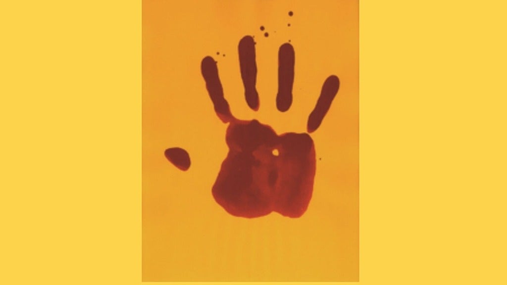 a red hand print on a mustard-coloured paper