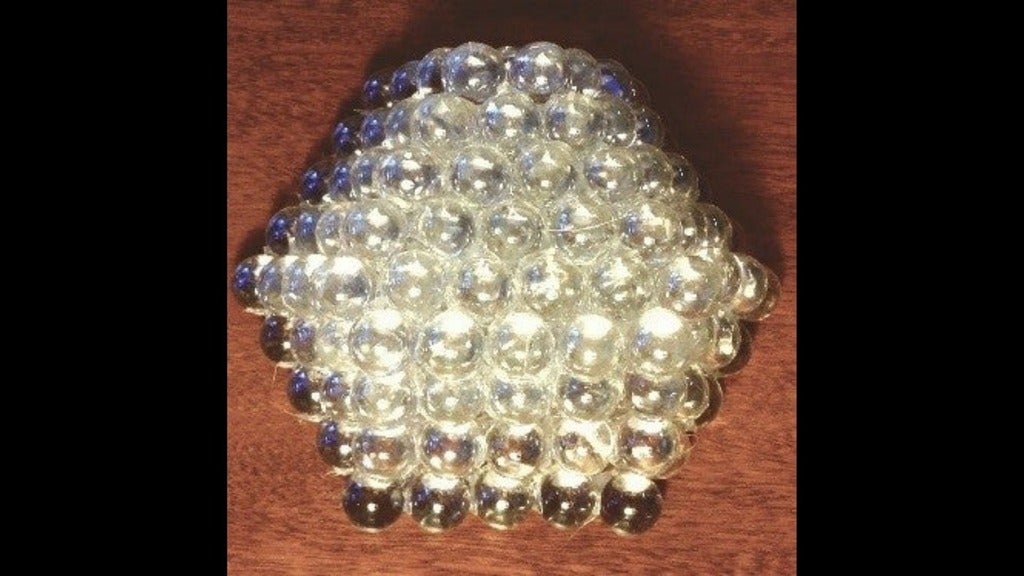 four layers of clear glass sphere stacked together to form a model of a nanoparticle
