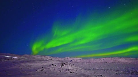 Scenic view of aurora borealis against sky at night. Iqaluit, Nunavut, Canada. Getty Images.