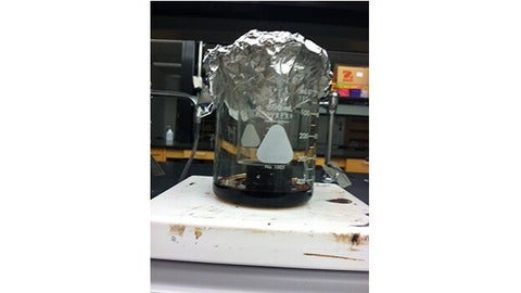 Aluminum foil filled with ice, small beaker and liquid inside large beaker.