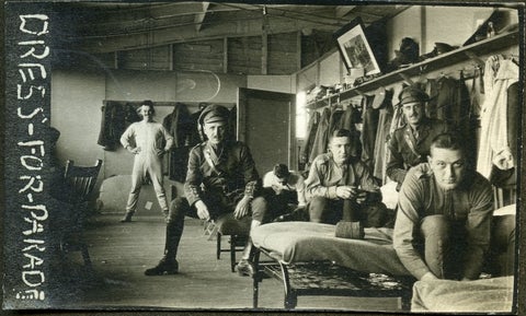 Barracks in Kitchener, with men getting dressed into military uniforms, 1910s.