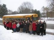 Group of people in front of a school bus