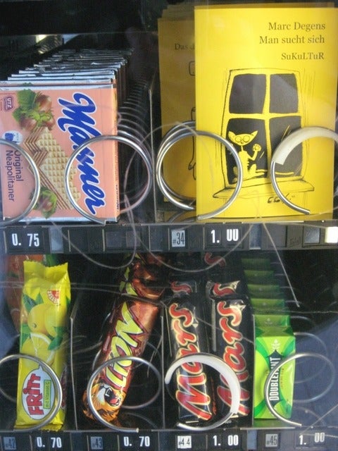 Close up of some items in a vending machine, including a book