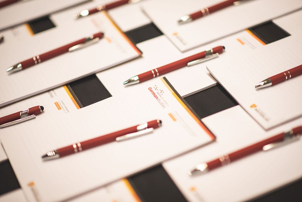 Pens displayed on notepads decoratively. 