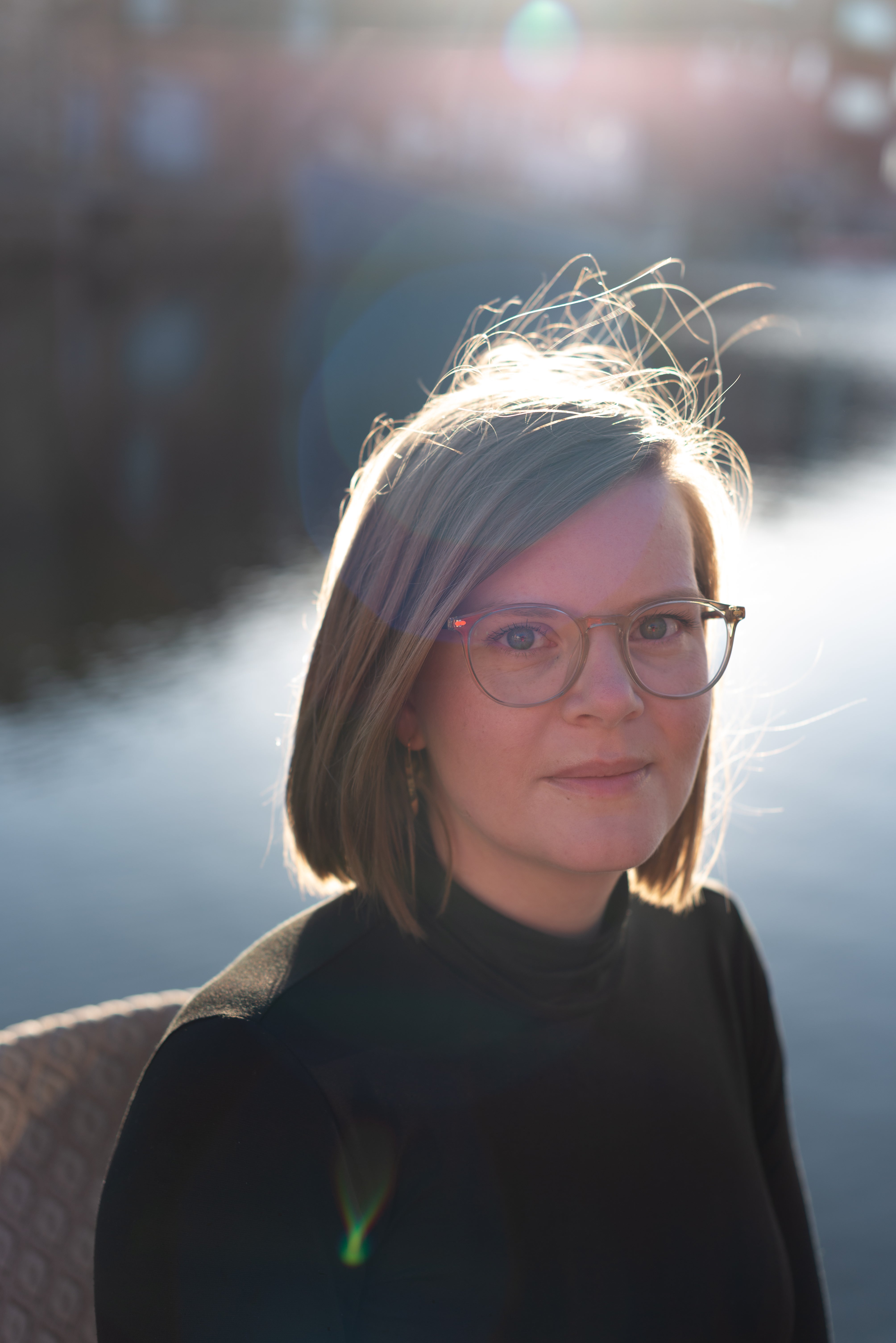 person sitting in front of water with glasses