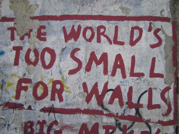 Graffiti on Berlin Wall: "The world's too small for walls"
