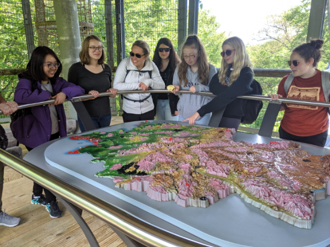 students in front of a topographic map of germany