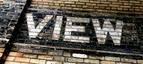 The word "view" on a brick wall