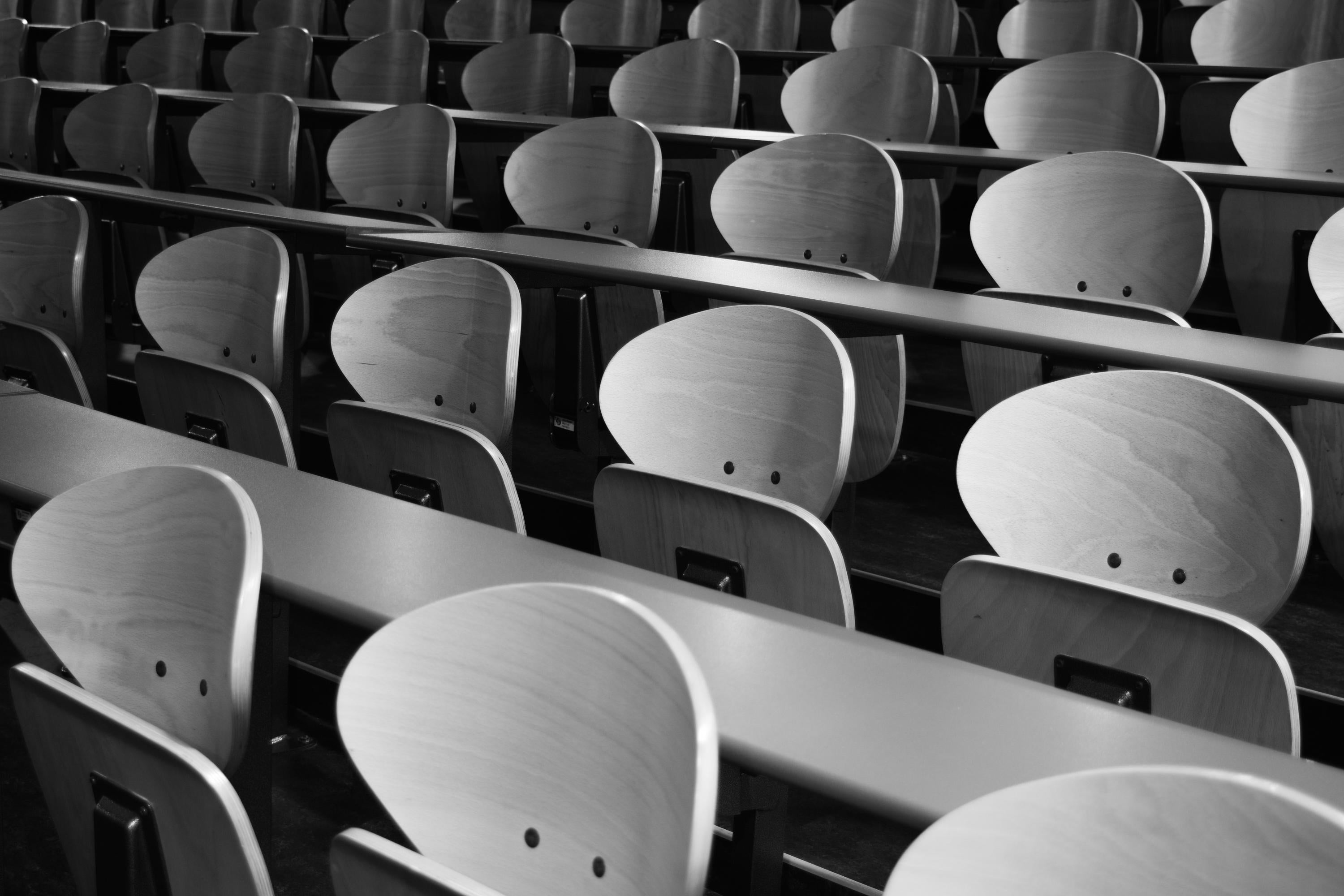 Black and white photo of lecture hall seating