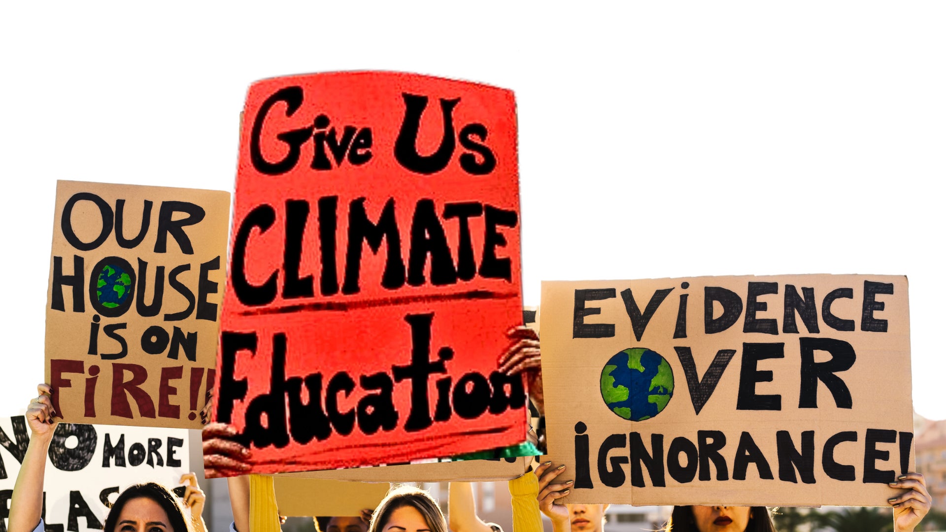 Three signs: "Our house is on fire!!", "Give Us CLIMATE Education", "Evidence Over Ignorance"