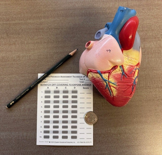 Immediate feedback assessment technique cards with a heart model next to them