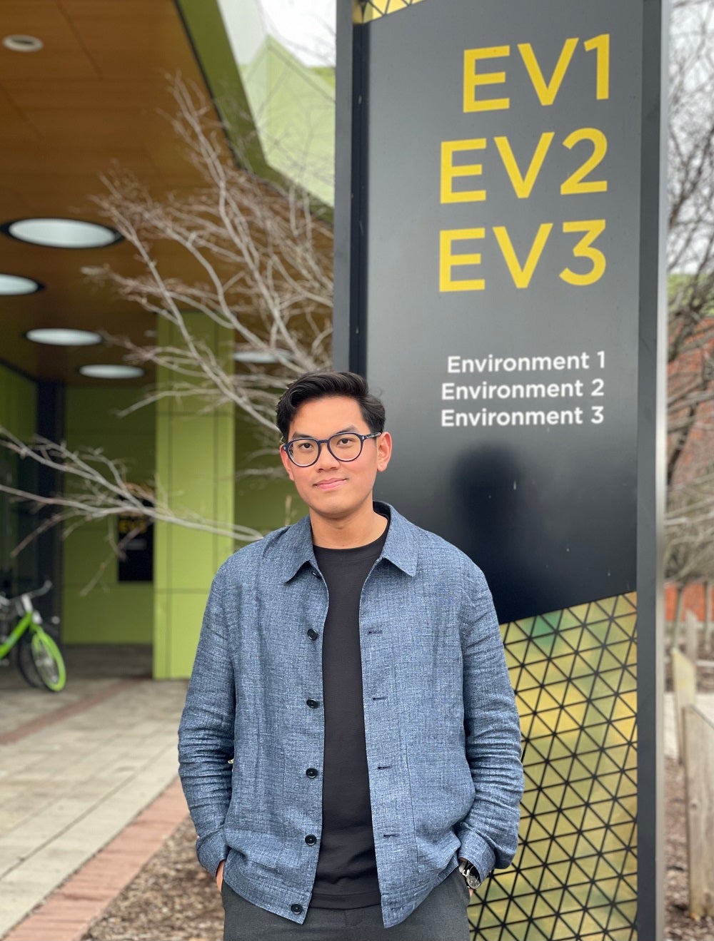 Ryan standing in front of the EV1, EV2 and EV3 sign