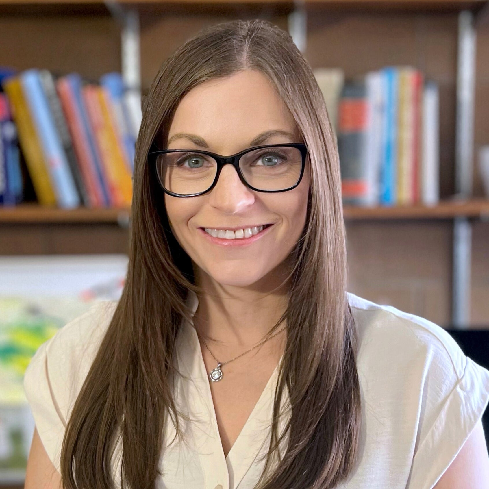 Women standing in front of a book shelf