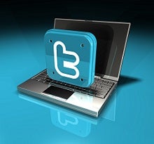 3D large metallic twitter logo on top of an open laptop computer