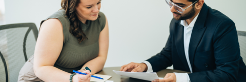 Two people looking over a document.