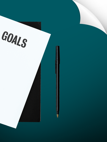 Link, notebook and paper that says "goals" with a pen.