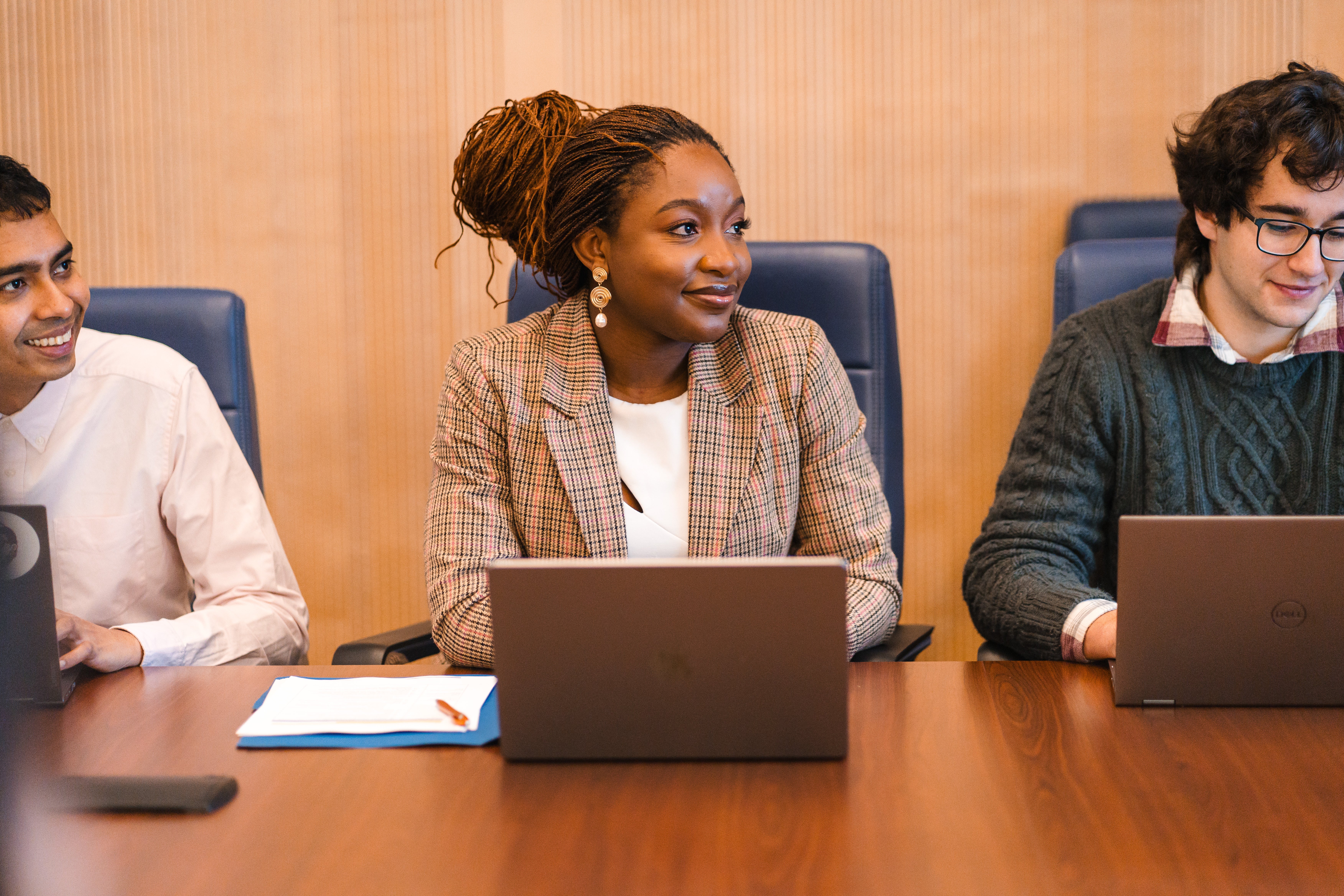 Students sitting on a table with laptops open