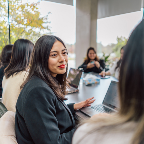 Students and Faculty working together at a table