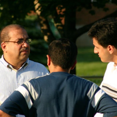 Dr. Raafat Mansour talking to two other attendees at BBQ 2005