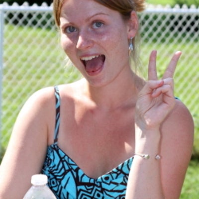 A female attendee giving a peace sign at BBQ 2010