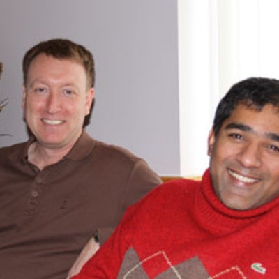 Bill Jolley and Neil Sarkar smiling at Christmas lunch 2010