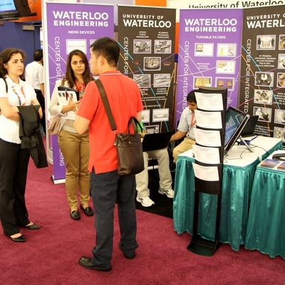 Students talking at booth