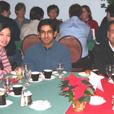 Two attendees with Dr. Raafat Mansour at Christmas lunch 2003