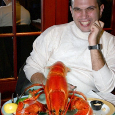 An attendee with a giant cooked lobster