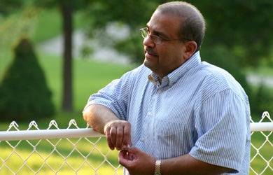 Dr. Raafat Mansour looking over the fence at BBQ 2005